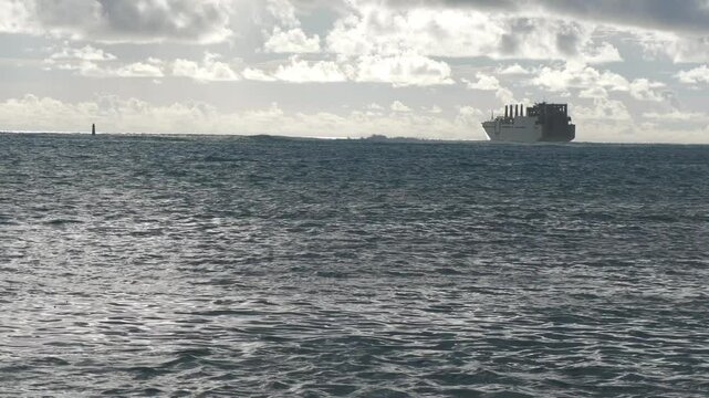 Wide view of the sea with a US navy preposition ship anchored at the lagoon, twilight shot