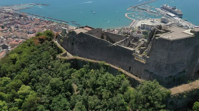 Aerial view from high altitude of Salerno city center and Arechi Castle on the mountain, Italy