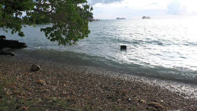 Side view footage from the Fishing Base in Saipan, CNMI with preposition ships in the distance, steady footage