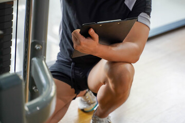 Closeup and crop Asian young officer of the gym and fitness trainer checking fitness equipment...