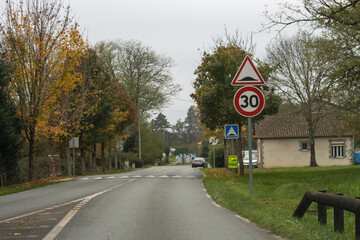 Dordogne rural road autumn foliage speed limit signs visible