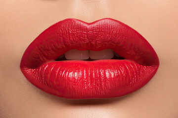 Obraz premium Close-up of bright red lipstick on plumped, Botox-treated lips