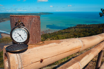 Antique Pocket Watch Overlooking Scenic Coastal Landscape