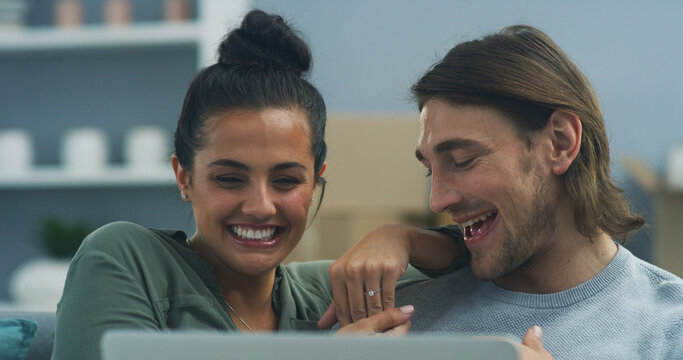 Home, happy couple and video call with laptop for ring, engagement proposal and announcement with digital. Sofa, woman and man with love with tech for jewelry, loyalty and commitment with promise