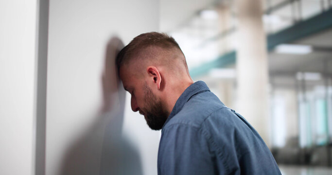 Sad Man Head Against Wall