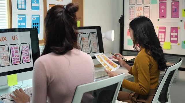 Web designer, mobile app development, creative planning, wireframe design, user experience concept, Asian female UX designer working on modern smartphone applications.