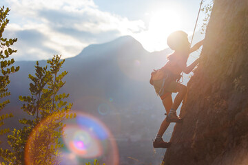 rock climber boy. child is practicing rock climbing. summer camp. sport in nature. cute teenager...