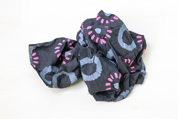 Beautiful batik cloth pieces with floral prints, isolated on a white background.