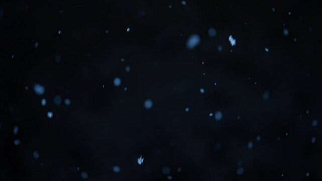 Falling snowflakes against a dark background, creating a serene winter atmosphere. Concept of peaceful snowfall, seasonal beauty, and tranquil weather conditions.