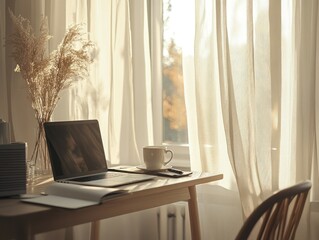 Fototapeta premium Sunlit home office workspace with laptop, notebook, coffee cup, and pampas grass.