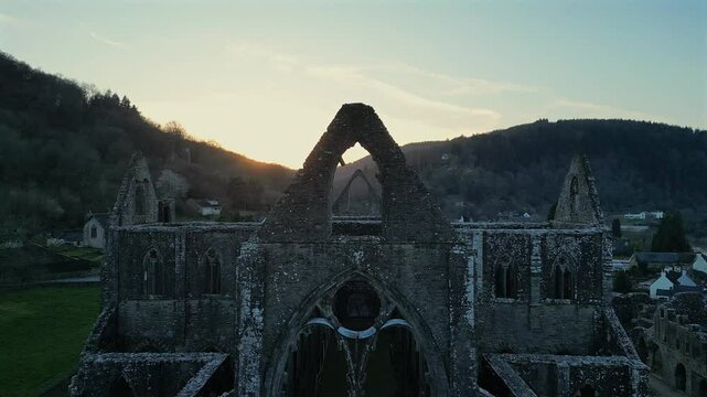 Drone footage of the ruins of Tintern Abbey at sunset in Tintern village in Monmouthshire, Wales, UK