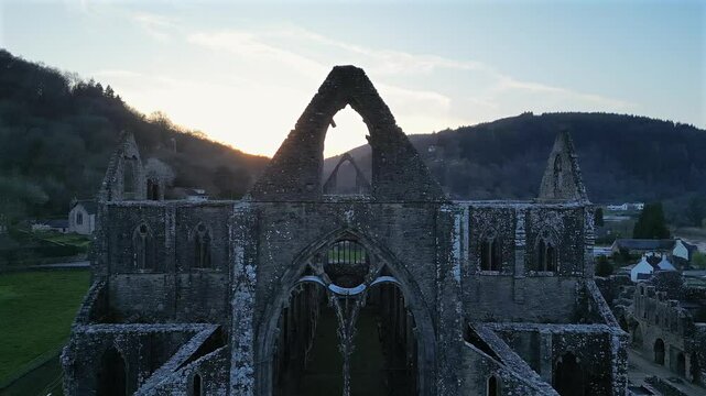 Drone footage of the ruins of Tintern Abbey at sunset in Tintern village in Monmouthshire, Wales, UK
