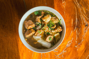 boiled Chinese pasta square on wood table