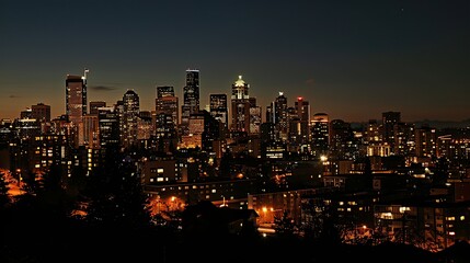 Fototapeta premium A city skyline at dusk, with glowing lights and tall buildings.
