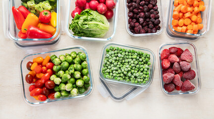 Boxes with fresh raw vegetables on table.