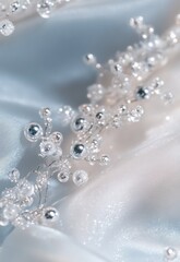 Delicate Silver Beaded Embellishment on Soft Satin Fabric, Showcasing Intricate Design and Reflective Surfaces Perfect for Bridal or Fashion Photographs
