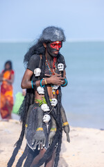 Kulasai Dasara, Portrait of indian male with painted face and dressed as hindu goddess kali to...