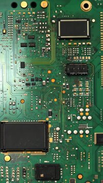 Detailed view of a green circuit board showcasing intricate electronic components and pathways