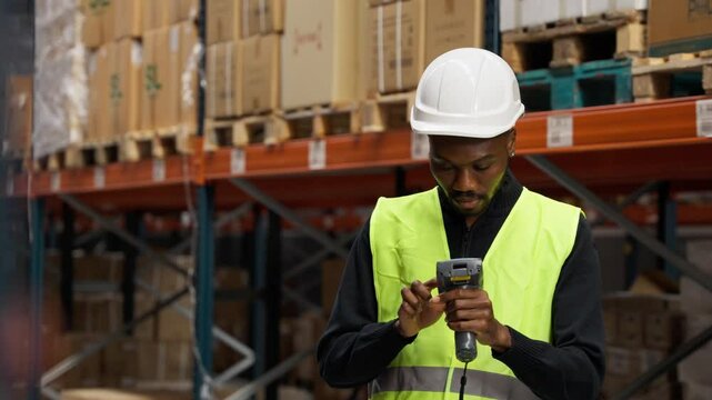 Warehouse worker scanning packages in logistic center in slow motion