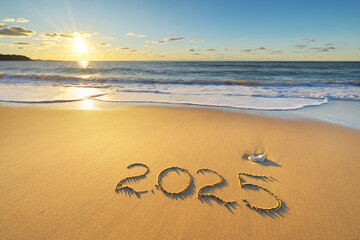 2025 year on the sea sand beach shore during sunset.