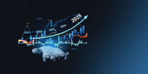 Hand holding financial graph forecasting growth from 2021 to 2025 on dark background.