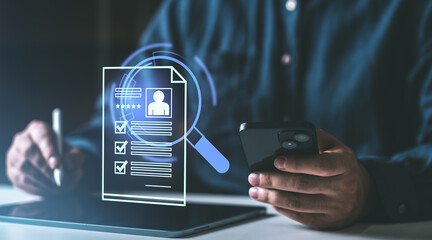 Digital recruitment process concept showing a person holding a mobile device and stylus with a floating digital resume interface on a dark background.