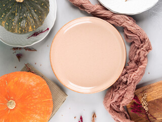 Fall thanksgiving table setting pumpkin decor flatlay with pink dish