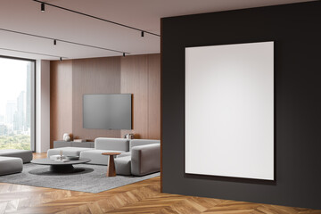 Blank poster mockup on black wall in modern living room with wooden and gray decor, large window. 3D Rendering
