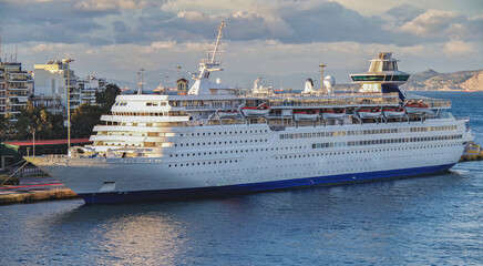 Classic cruiseship cruise ship liner Olympia in port of Piraeus, Athens Greece during sunrise with...