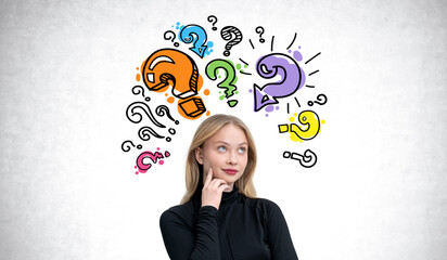 Woman thinking with colorful question marks surrounding her head