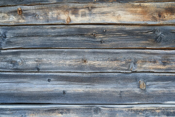 Fototapeta premium Close-up of horizontal wooden planks showing signs of weathering, age, and remnants of faded paint.