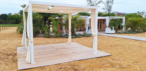 Beach cabanas near the spa center on the seashore. Panorama.