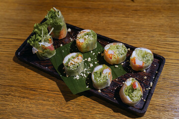 Goi cuon tom thit or Vietnamese summer rolls with shrimp. Cooked prawns or shrimp are wrapped in rice paper with fish mint leaves, bean sprouts, lettuces, mints, and noodles. Dip in cured fish sauce