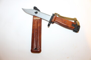 A folding knife features a sleek metal blade with a stylish wooden handle and a safety latch, ideal for outdoor activities like camping or crafting.