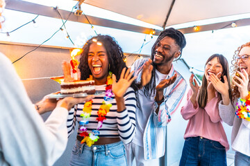 Woman celebrating her birthday with her multiracial friends