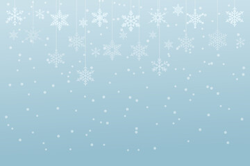 Snow flakes in gradient white and blue hanging and floating on soft blue background