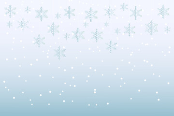 Snow flakes hanging and floating on gradient blue and white background