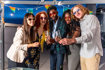 Friends toasting with champagne in a roof party