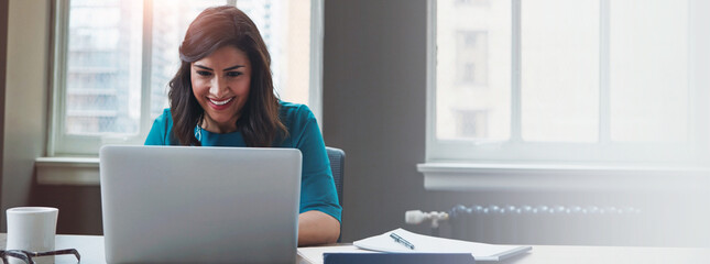Business, female financial advisor and laptop in office to review clients saving plan, reading profit data and revenue. Banner, woman and happy at desk for wealth management or investment strategy