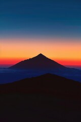 Obraz premium Dramatic mountain silhouette at sunset scenic landscape nature views bold and striking design