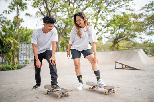 At the bustling skatepark, two young skateboarders enthusiastically share their tips and tricks - Powered by Adobe