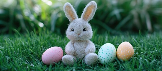 Colorful Easter eggs and a soft toy bunny sitting on vibrant green grass creating a festive spring atmosphere
