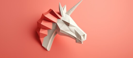 Coral colored 3D papercraft unicorn head model in minimal art style showcasing geometric design and creativity