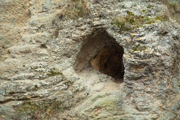 Dark rocky cave entrance in Armenia.