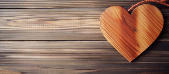 Wooden heart ornament on rustic wooden background symbolizing love and warmth in a cozy home decor setting.