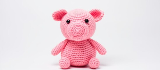 Handmade crochet pink pig toy on white background perfect for children DIY gift idea for holidays with ample copy space for branding or text