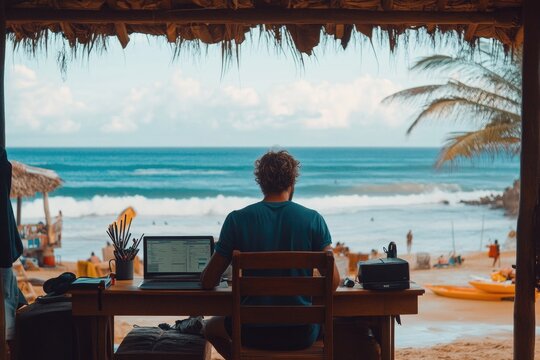 Freelancer working remotely from tropical beach hut with ocean view