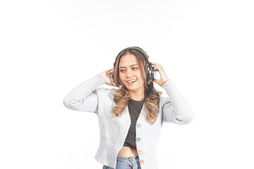 Naklejka premium Young woman with wearing headphones listening to her favorite music.