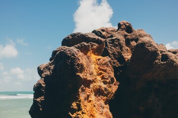 Volcanic rock formation under blue sky.