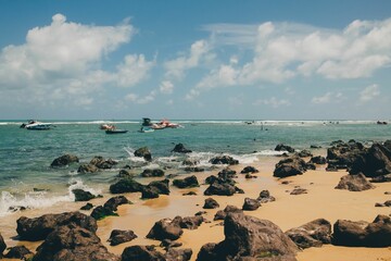 Rocky beach with boats on turquoise sea